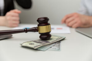 Legal alimony concept. Closeup view of wooden gavel and money.
